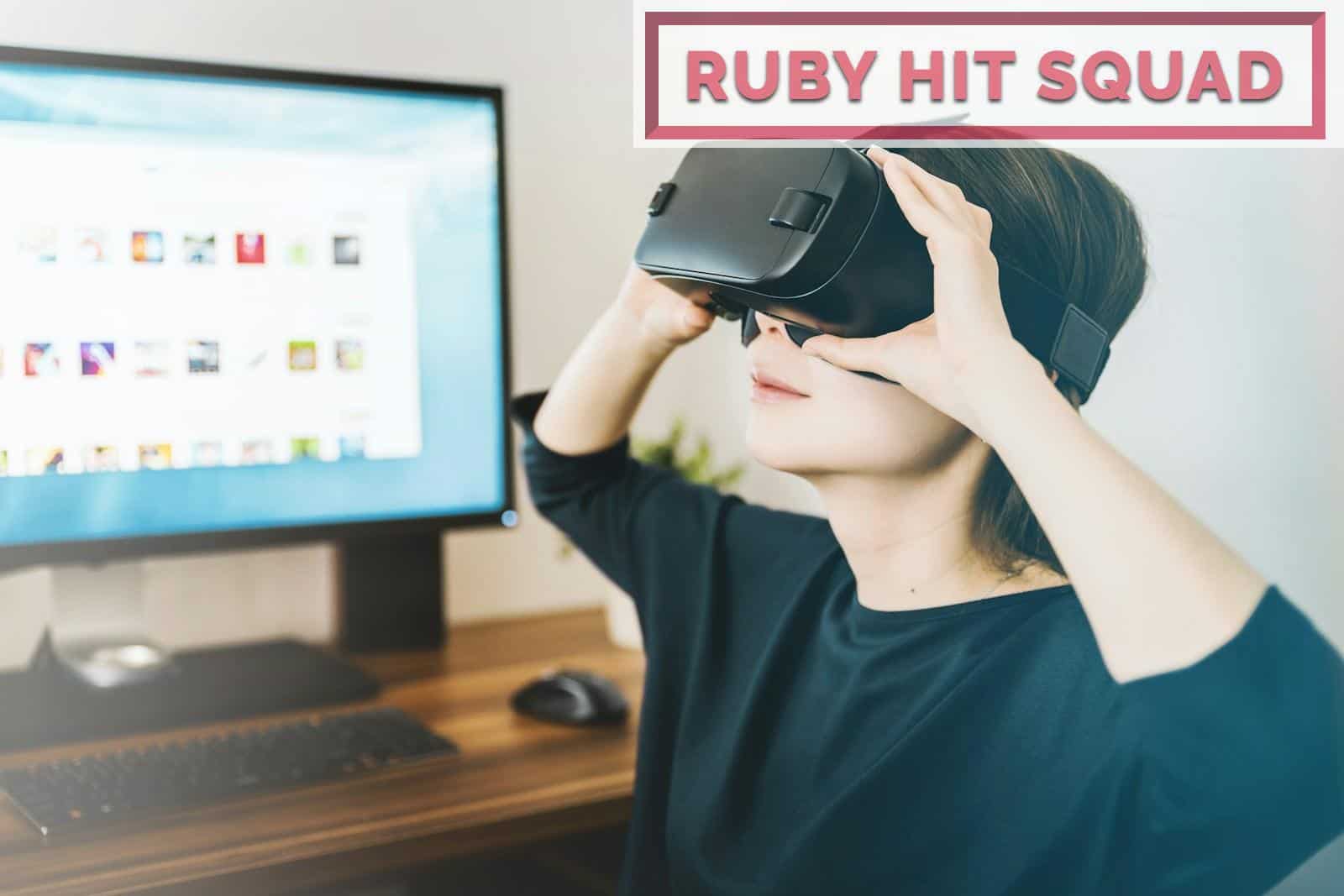 woman using black VR headset beside computer